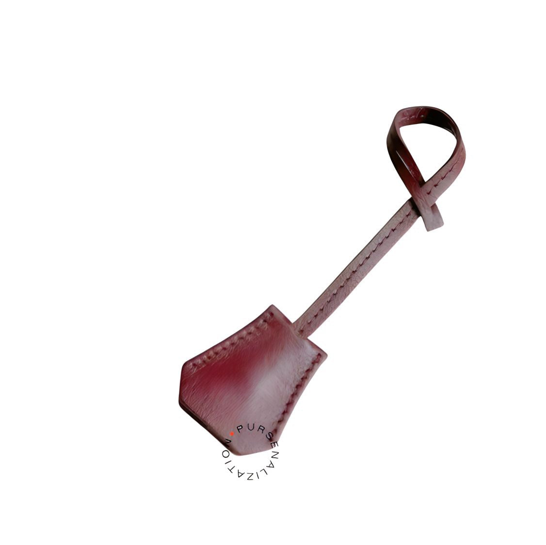An image of a clochette leather charm for handbags accessories in the variety Ciel, a shade of dark brown.