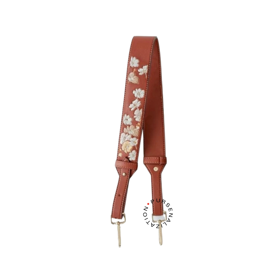 An image of a leather strap adorned with white and yellow buttercup flower embroidery, used for handbags in the variant Biscuit, a medium reddish shade of brown