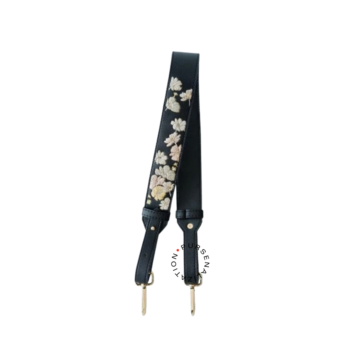 An image of a leather strap adorned with white and yellow buttercup flower embroidery, used for handbags in the variant Cuivre, a very dark gray with a cool blue tinge.