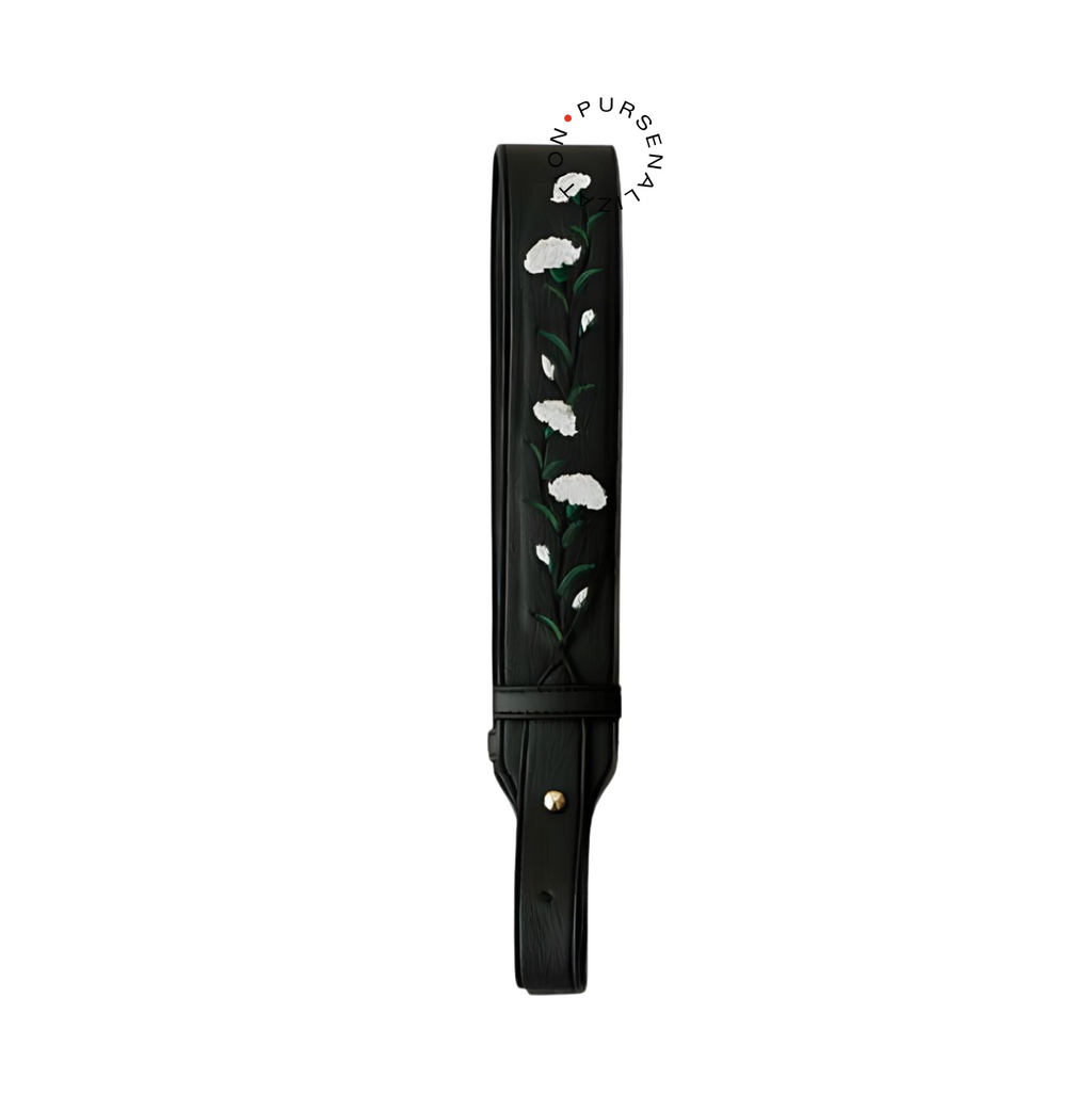 An image of a leather strap adorned with white marigold flower embroidery, used for handbags in the variant Noir, a shade of black.