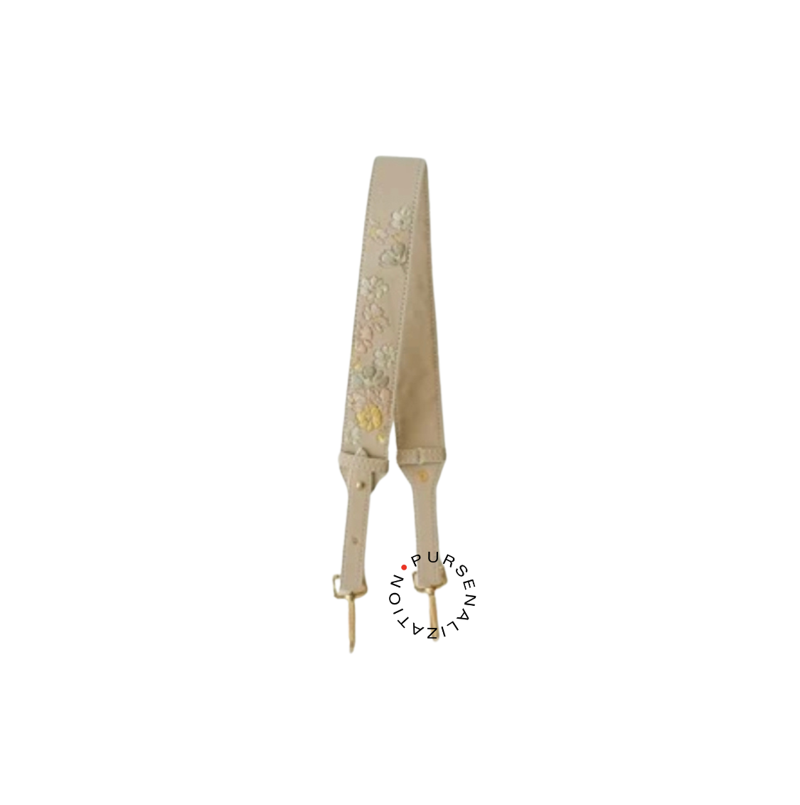 An image of a leather strap adorned with white and yellow buttercup flower embroidery, used for handbags in the variant Sesame, a shade of a light cream with a hint of yellow